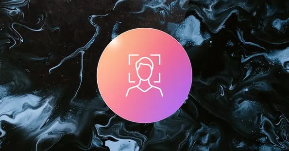 A pink bubble depicting a person’s face being analyzed on a black and white background.